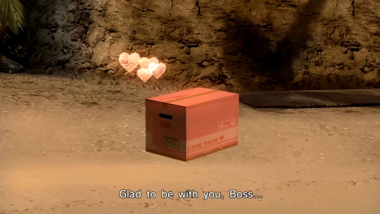 Screenshot from Metal Gear Solid Peace Walker. A cardboard box marked "Love Pack" sits on a beach, with hearts coming out. "Glad to be with you, Boss..."